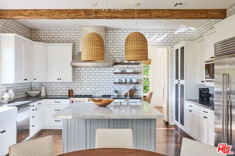 a kitchen with stainless steel appliances a sink stove and refrigerator
