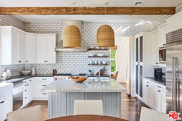 a kitchen with stainless steel appliances a sink stove and refrigerator