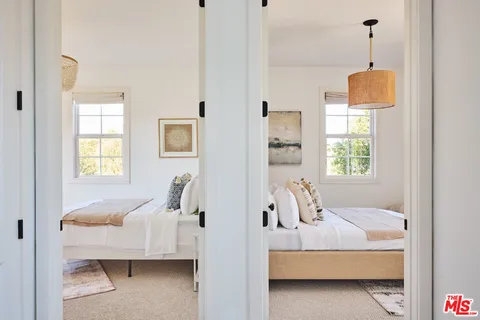 a bathroom with a granite countertop sink a toilet and with mirror