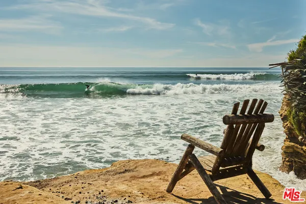 a view of swimming pool with chair and table