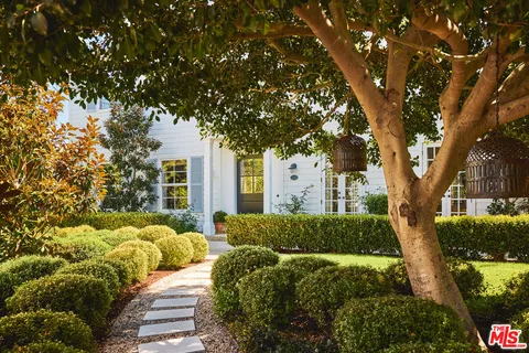 a view of backyard of house with outdoor seating and green space