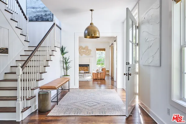 a view of an entryway with wooden floor