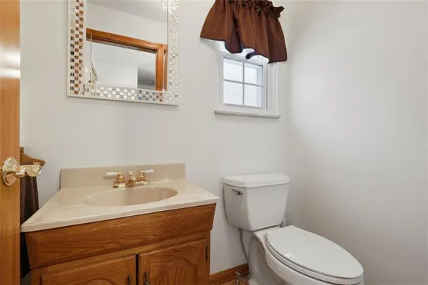 a bathroom with a sink a toilet and mirror