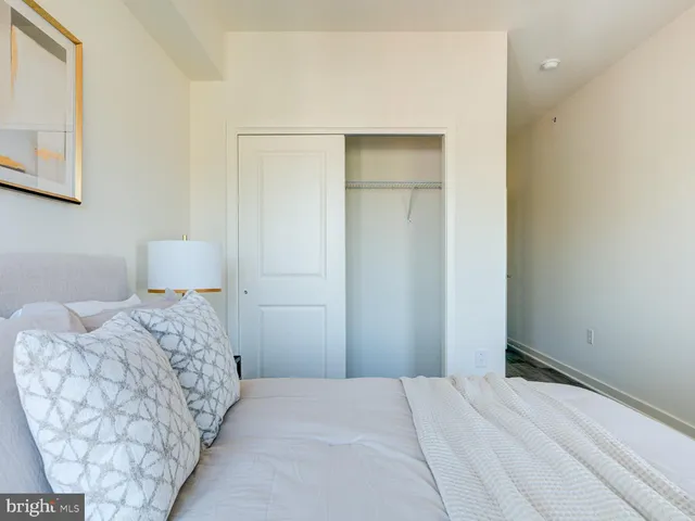 a bedroom with a bed and a mirror
