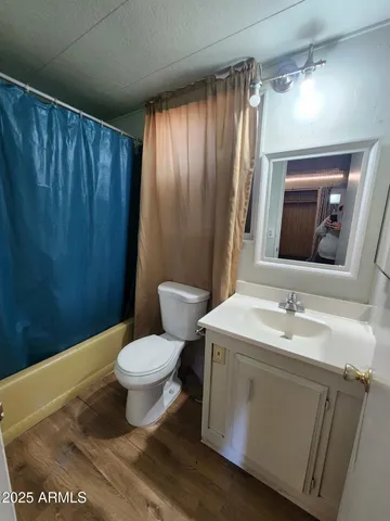 a bathroom with a sink toilet and mirror