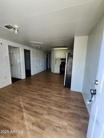 a view of a livingroom with wooden floor and staircase