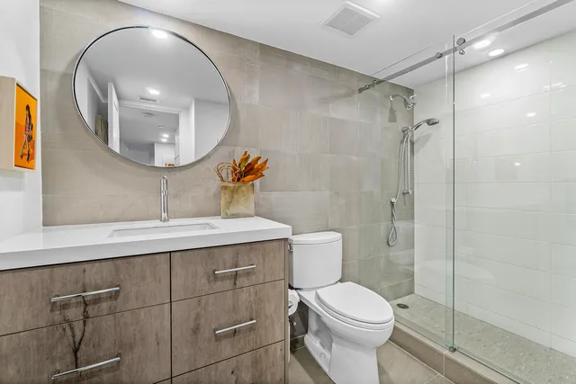 a bathroom with a toilet a sink and mirror