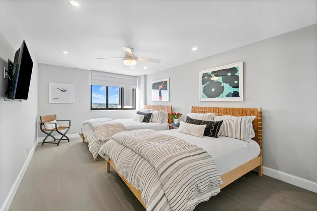 a bedroom with bed and a flat screen tv