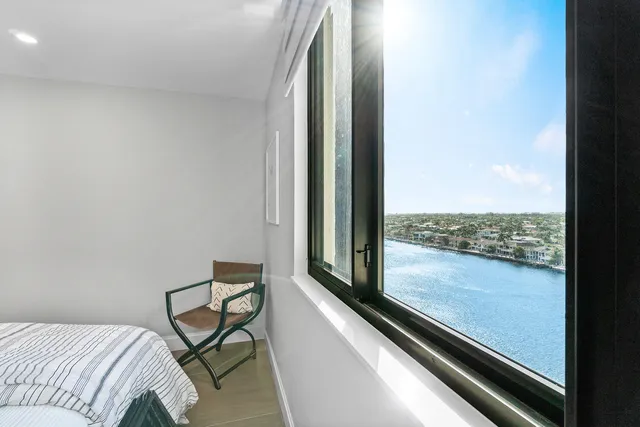 a view of a balcony with chair and outside view