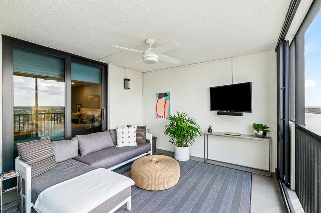 a living room with furniture and wooden floor