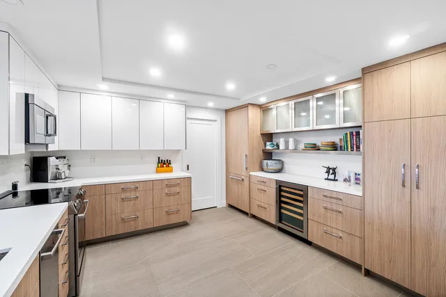 a kitchen with white cabinets and white appliances