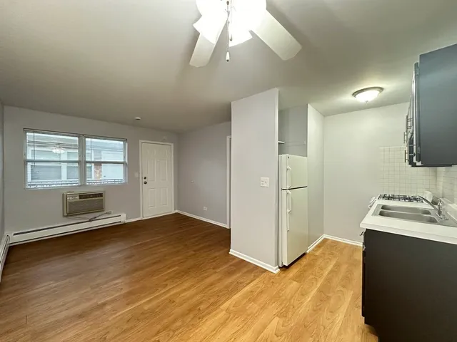 a view of a kitchen with wooden floor and a sink