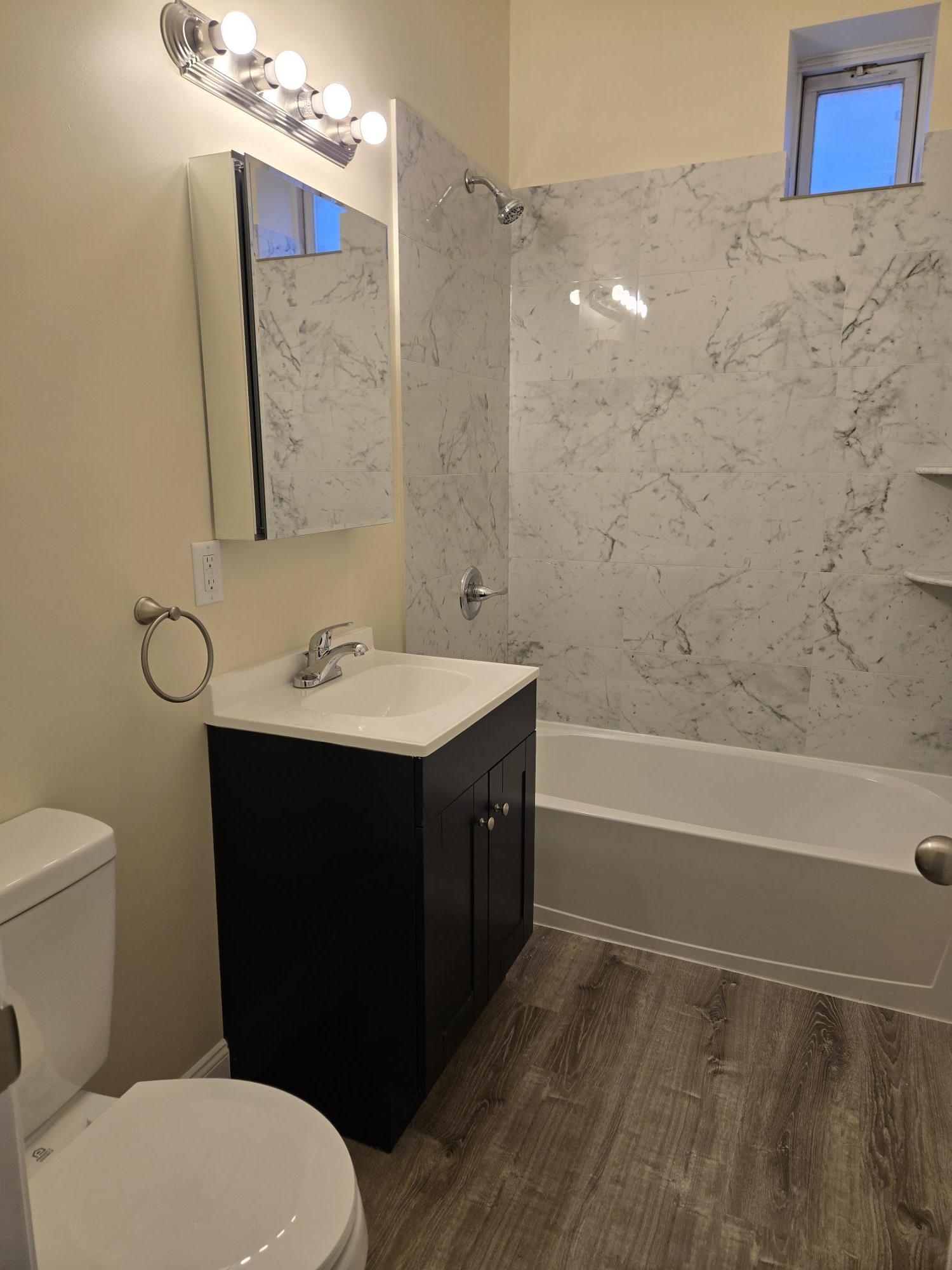 289 Day Avenue, Unit A2 Fairview, NJ 07022 - Photo 2 of 6 a bathroom with a sink a toilet and shower