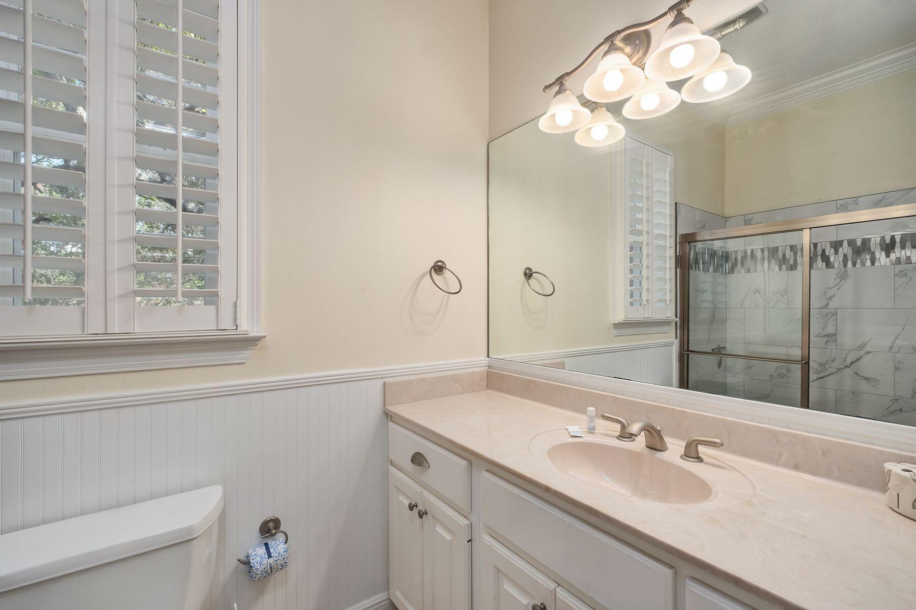 352 Cassine Garden Circle Santa Rosa Beach, FL 32459 - Photo 18 of 43 a bathroom with a sink vanity granite and a mirror
