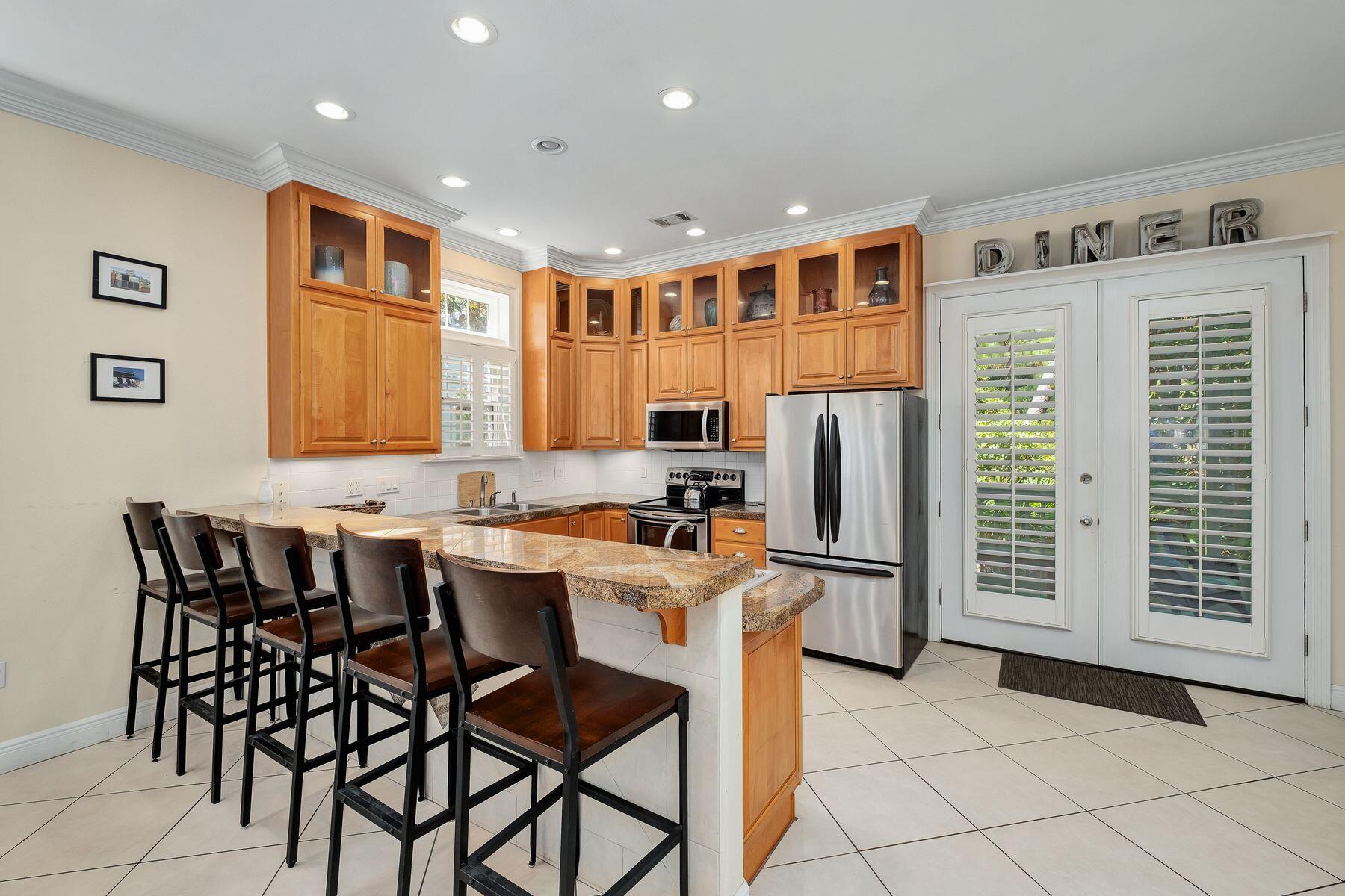 352 Cassine Garden Circle Santa Rosa Beach, FL 32459 - Photo 3 of 43 a kitchen with stainless steel appliances granite countertop a refrigerator and a stove top oven