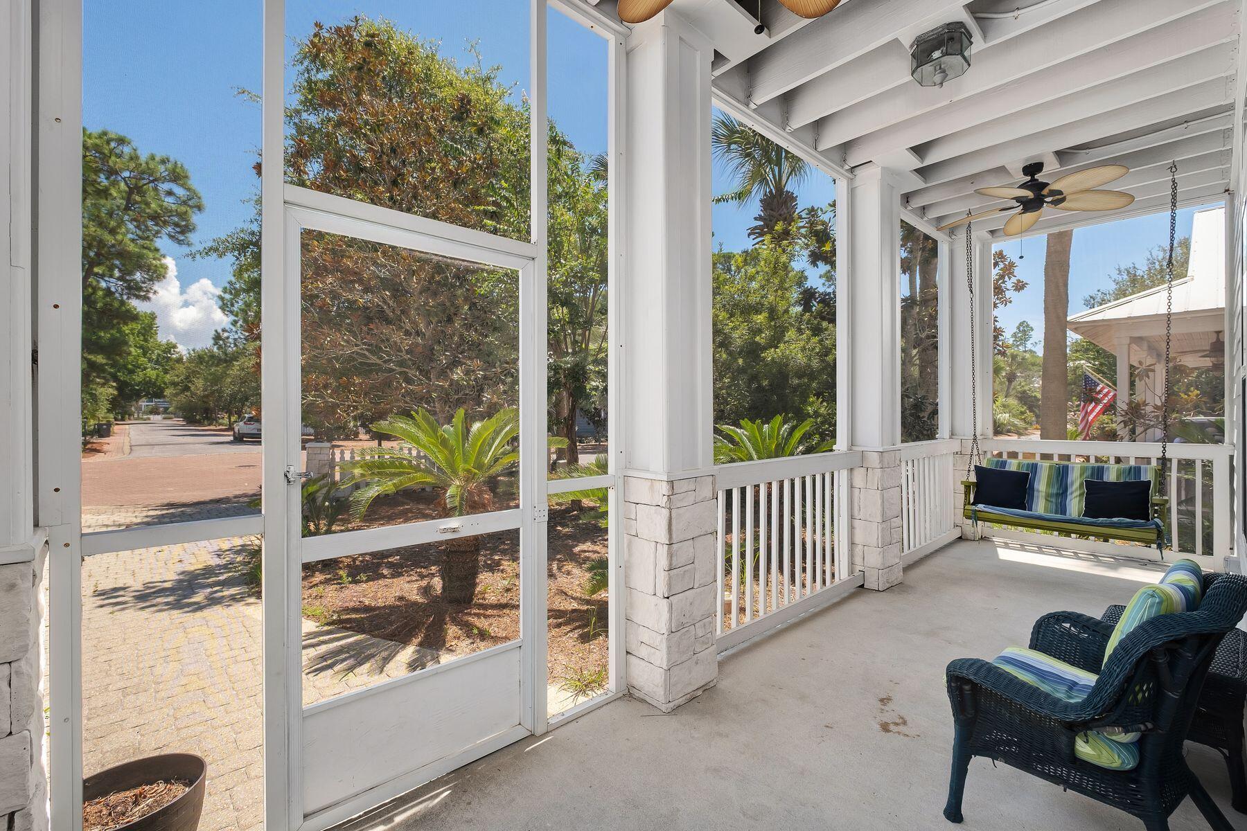 352 Cassine Garden Circle Santa Rosa Beach, FL 32459 - Photo 32 of 43 a view of a porch with furniture and floor to ceiling window