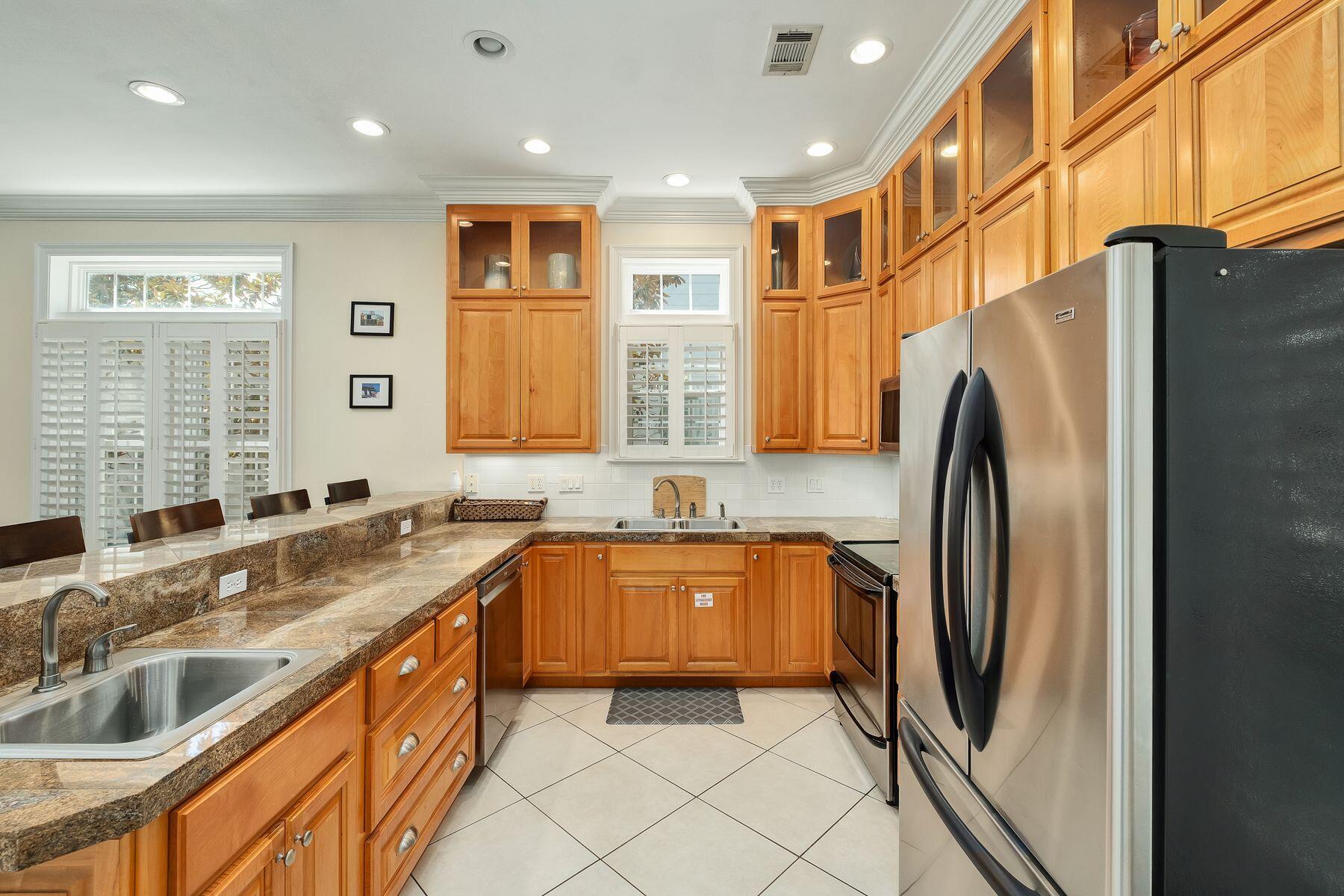 352 Cassine Garden Circle Santa Rosa Beach, FL 32459 - Photo 4 of 43 a kitchen with stainless steel appliances granite countertop a refrigerator a sink a stove and island