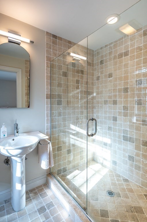 18 Fox Hill Road Newton, MA 02459 - Photo 26 of 37 a bathroom with a sink shower and a mirror
