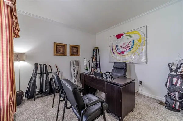 a living room with furniture a fireplace and a large window