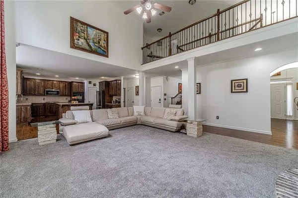 a kitchen with stainless steel appliances granite countertop a refrigerator a stove top oven a sink and dishwasher
