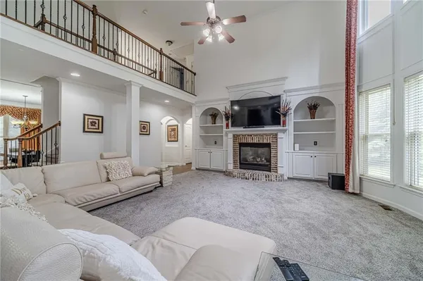 a kitchen with stainless steel appliances granite countertop a refrigerator a stove and a sink