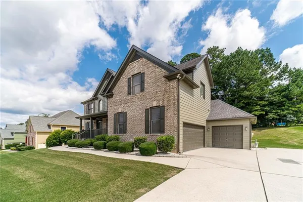 a front view of a house with a yard and garage