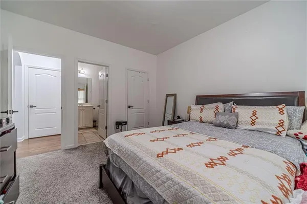 a bedroom with a bed and a potted plant