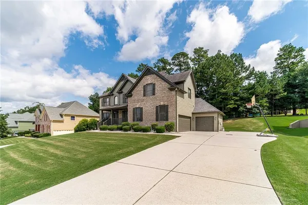 a front view of house with yard and green space