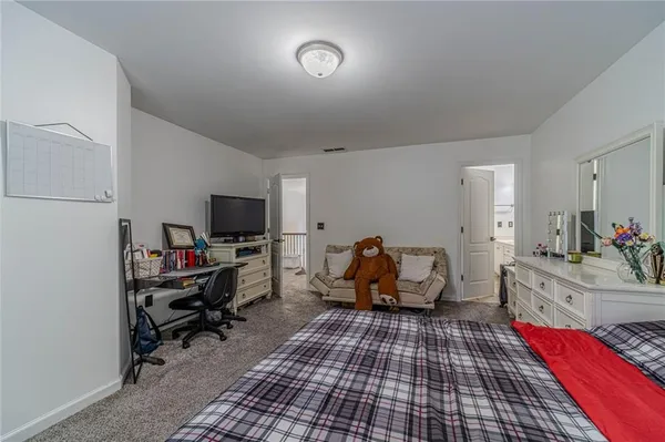 a spacious en suite bathroom with a tub shower and sink
