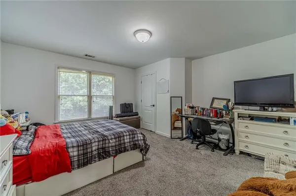 a bedroom with bed and window