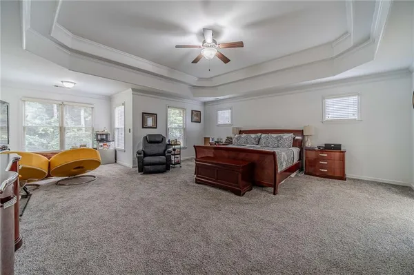 a front view of a house with a garden and outdoor seating