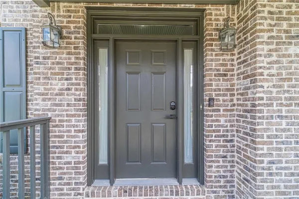 a dining room with furniture large windows and a chandelier