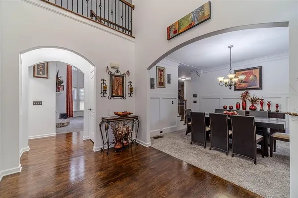a view of a dining room with furniture and a chandelier