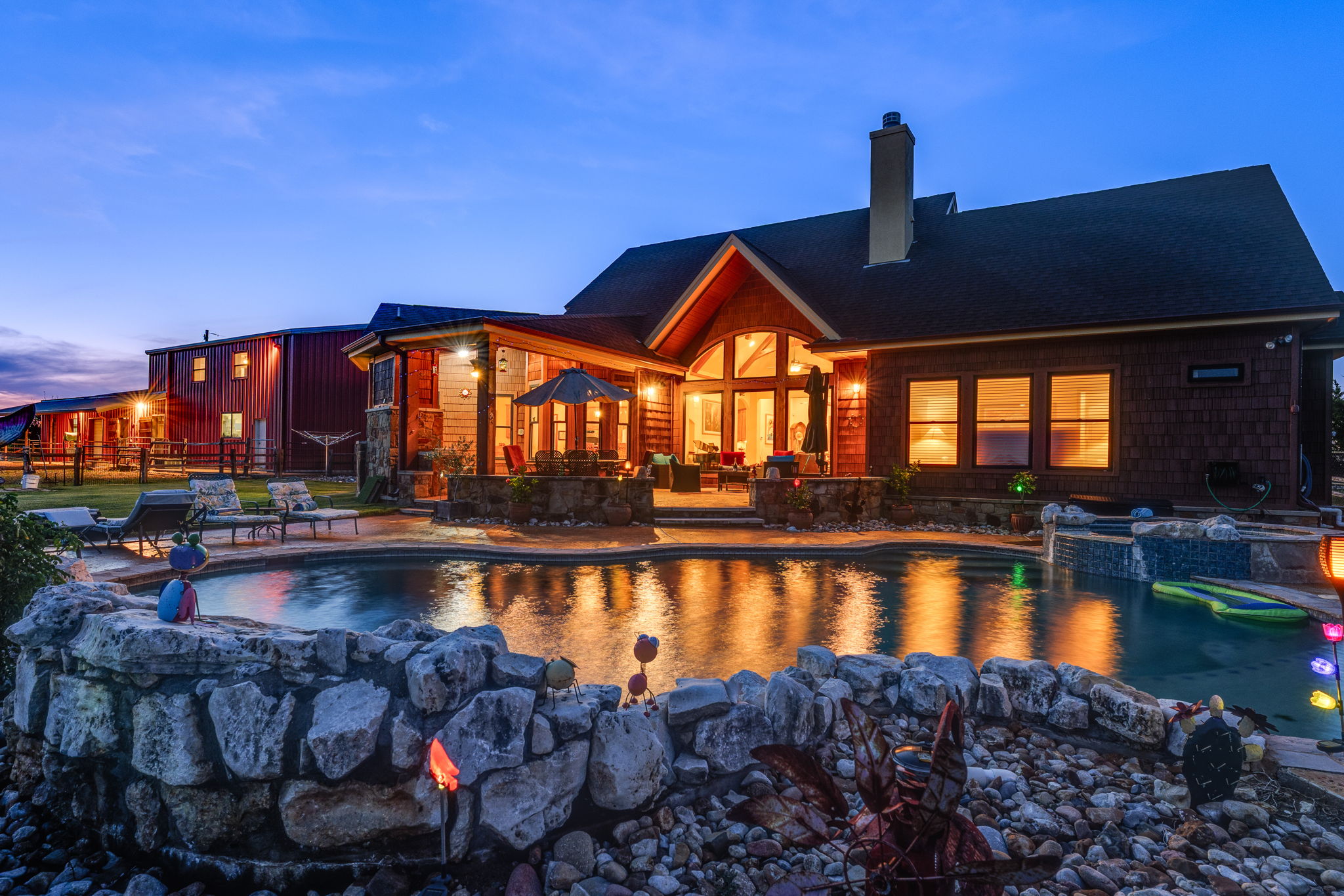 Outdoor pool with an in-ground hot tub and a patio area