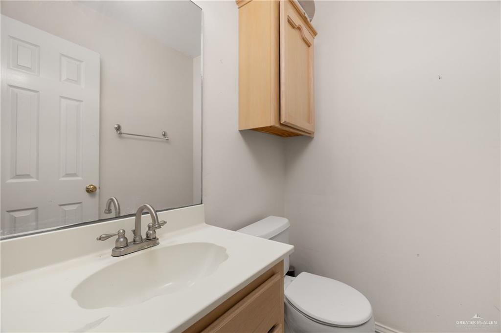 2210 Morning Lane Mission, TX 78572 - Photo 14 of 20 a bathroom with a sink a toilet and mirror