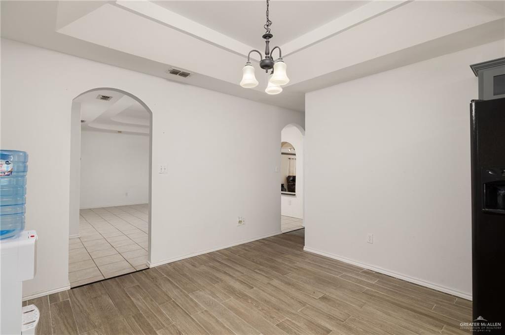 2210 Morning Lane Mission, TX 78572 - Photo 7 of 20 an empty room with wooden floor and cabinet