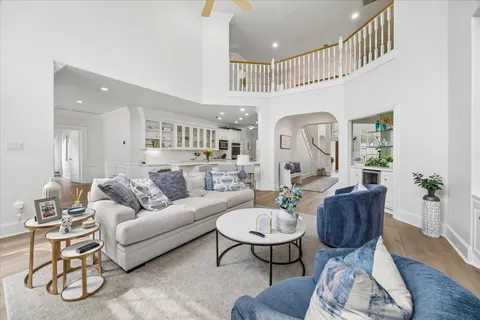 a living room with furniture and wooden floor
