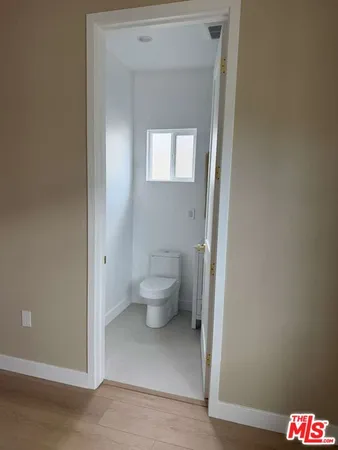 a bathroom with a shower sink mirror and toilet