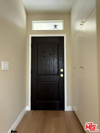 a view of front door with wooden floor