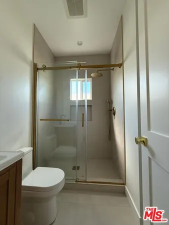 a bathroom with a toilet and a shower