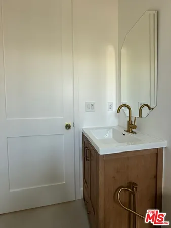 a bathroom with a sink and mirror