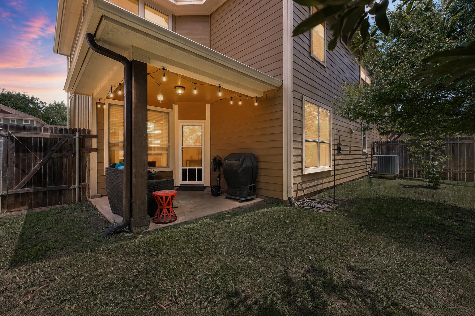 6708 Menchaca Road, Unit 10 Austin, TX 78745 - Photo 25 of 28 Covered patio with string lighting, concrete flooring, and a wood-paneled exterior