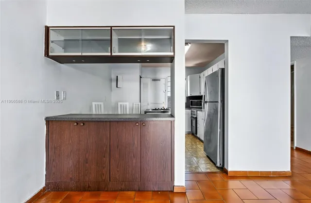 a kitchen with granite countertop a stove sink and cabinets