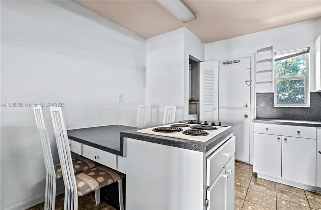 a kitchen with stainless steel appliances granite countertop a refrigerator and a stove