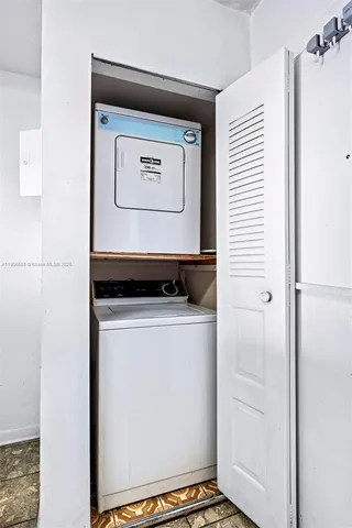 a kitchen with granite countertop a sink stove and white cabinets