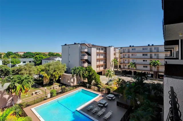 a view of yard from deck with patio