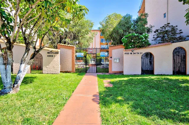 a front view of a multi story building with a yard