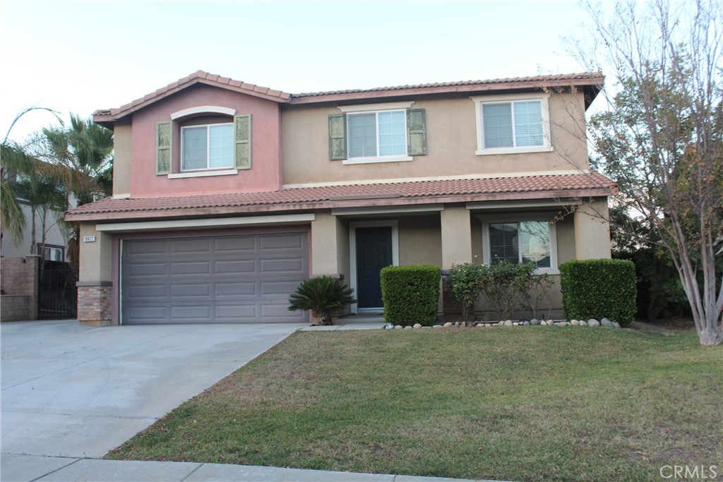 a front view of a house with a yard and garage