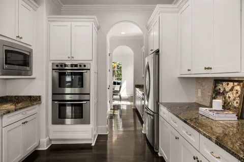 a kitchen with stainless steel appliances granite countertop a stove a sink and a microwave