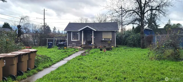 a view of a house with yard and a garden